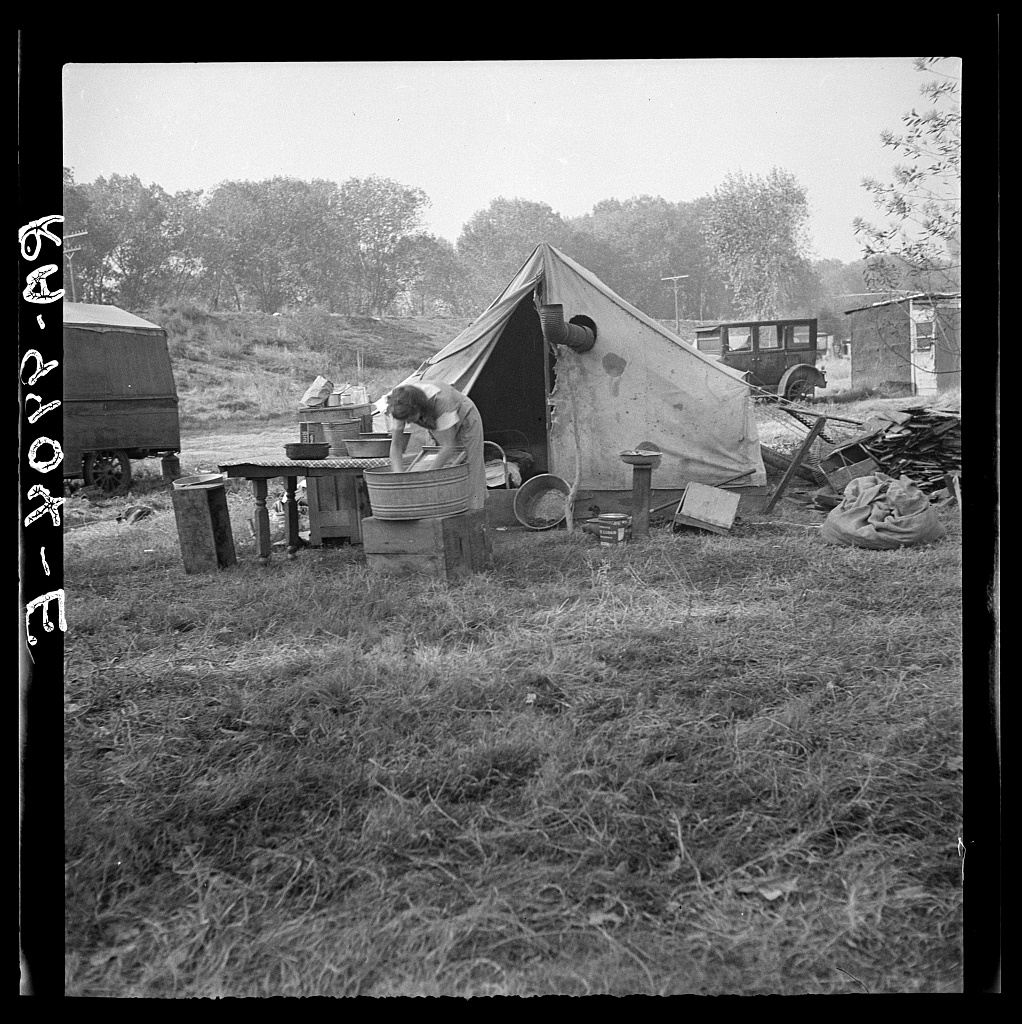 A Tennessee migrant family's camp on the American River near Sacramento, 1936. The mother worked in a fruit cannery.