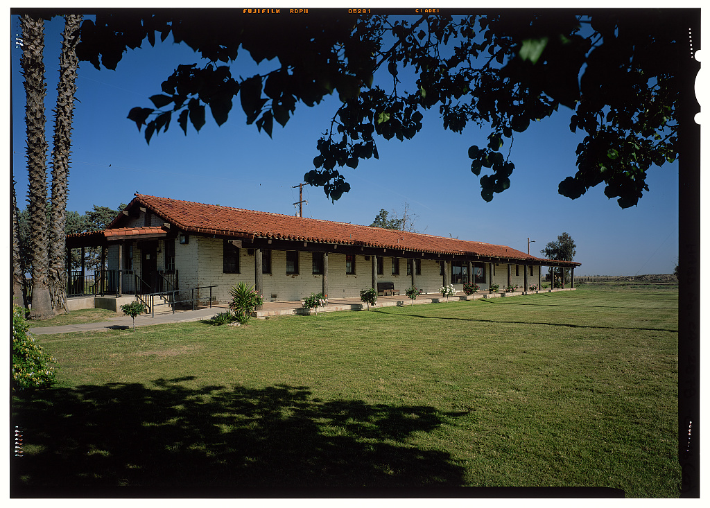 The Rodrigo Terronez Memorial Clinic building at the Forty Acres site in Delano, California, mission-style architecture with a red tile roof.